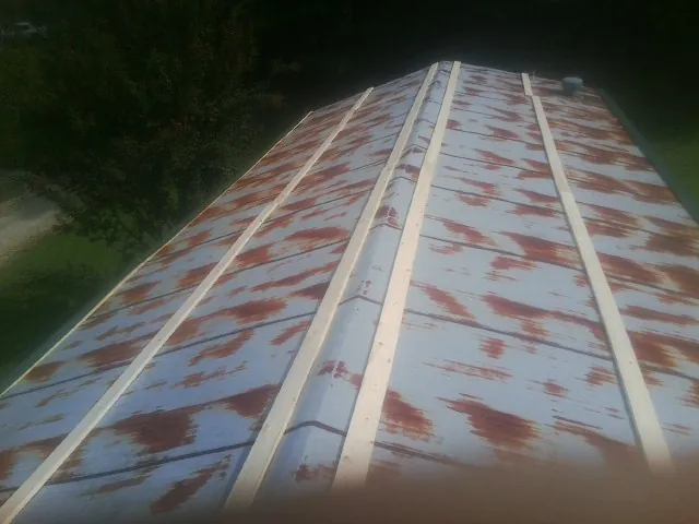 Rusted metal roof panels with new wood purlins before replacement — Storm Damage Roof Repair in Harker Heights by Roofing Brothers